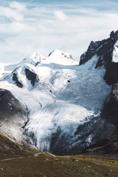 Dramatic panoramic view of big melting glacier, wood cabin and Monte Rose mountain in Zermatt region, Valais canton, Switzerland