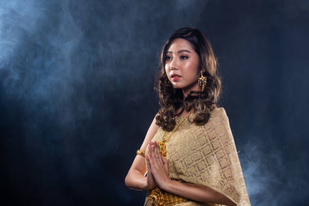 istock Thai Traditional Dress in dark backgrounds smoke 1176769604