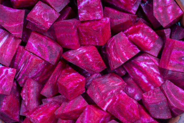 istock Fresh segments of a red beetroot, closeup. Purple beet slices background, top view 1176769809