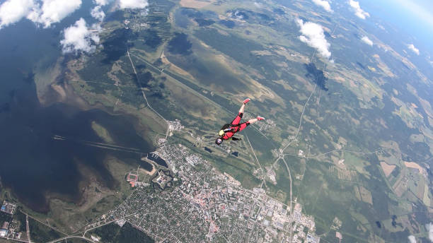 istock Skydiver falls through clear skies, in aerial flight 1176769851
