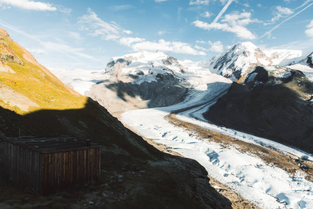 Dramatic panoramic view of big melting glacier, wood cabin and Monte Rose mountain in Zermatt region, Valais canton, Switzerland