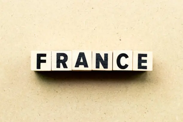 Photo of Letter block in word France on wood background