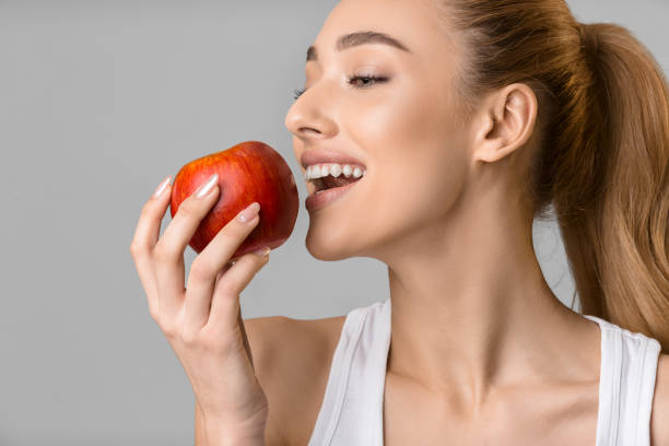 istock Healthy eating. Girl biting fresh red apple 1176771036
