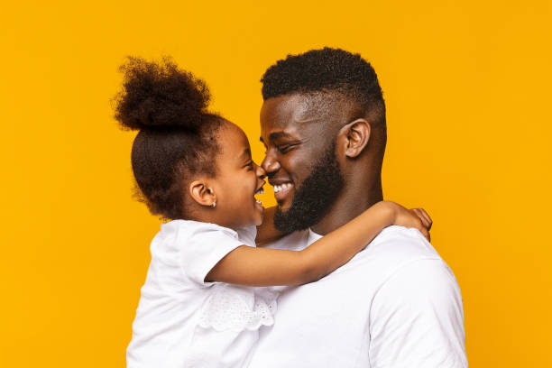 istock African daddy and his little daughter touching noses 1176771959