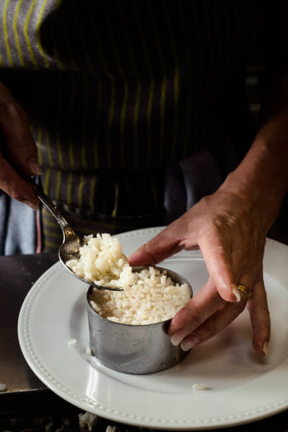 istock woman filling a mold with cooked rice 1176773549