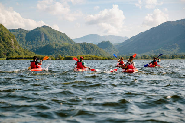 Friends Learning To Kayak Friends learning to kayak on Derwent Water in The Lakes District in Cumbria cumbria photos stock pictures, royalty-free photos & images