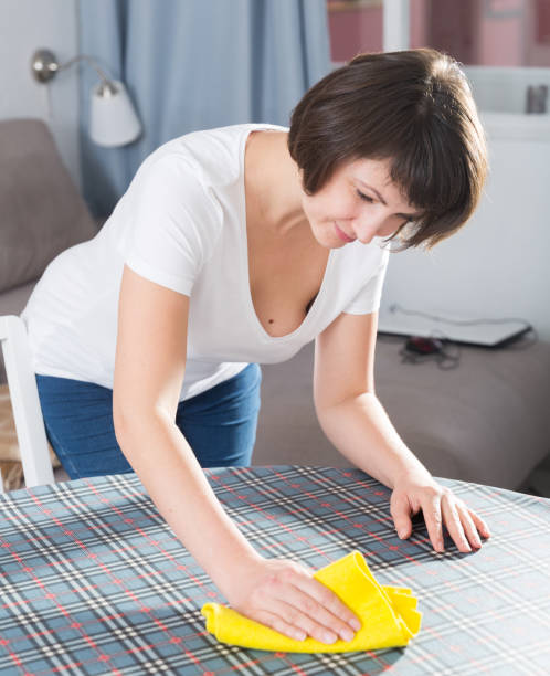 istock Woman with rag cleaning kitchen 1176776491