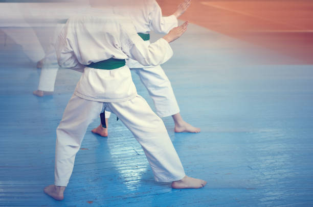istock Kids training on karate-do. Banner with space for text. Retro style. For web pages or advertising printing. Photo without faces. 1176777690