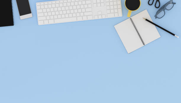 istock Top view of workplace with accessories,business text space on table,Notebook,keyboard,cup of black coffee,pencils and computer. 3D rendering. 1176777883