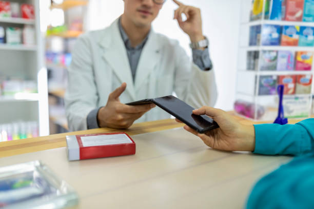istock Woman making a contactless payment at the pharmacy 1176778013