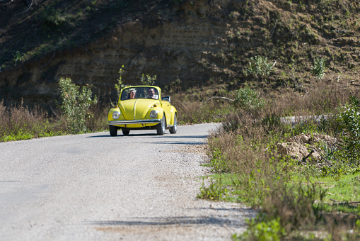 Antalya, Turkey - April 9, 2017 Happy young couple enjoying in drive with Volkswagen Beetle