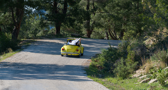 Antalya, Turkey - April 9, 2017 Happy young couple enjoying in drive with Volkswagen Beetle