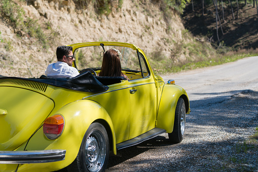 Antalya, Turkey - April 9, 2017 Happy young couple enjoying in drive with Volkswagen Beetle
