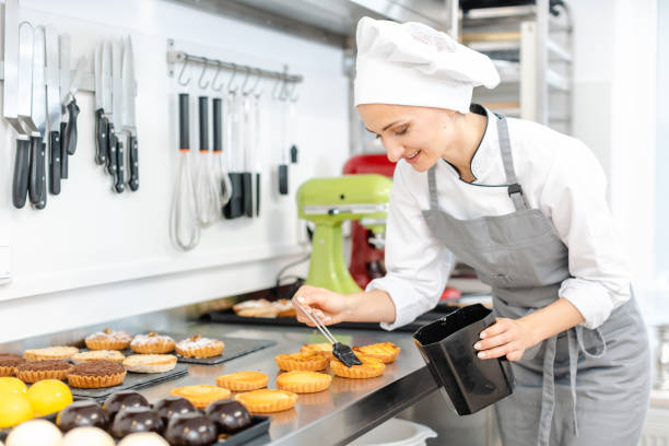 istock Pastry chef glazing little cakes 1176782436