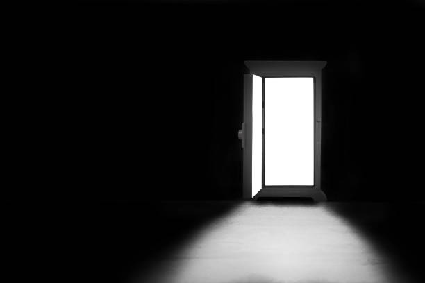 istock Light shining through opened door in dark room. 1176782758