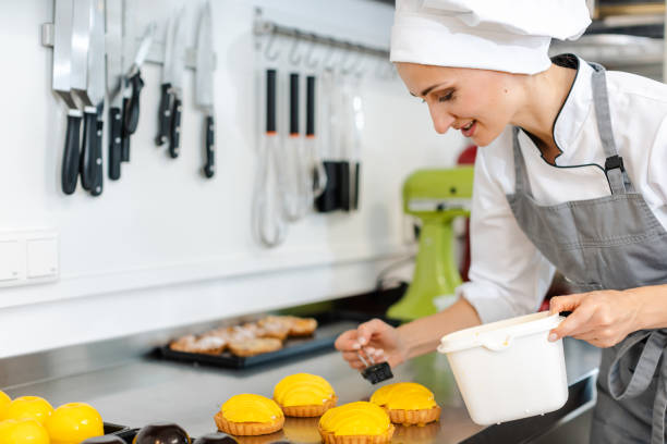 istock Confectioner working on sweet little cakes 1176785076