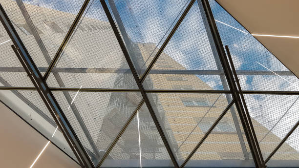 istock Structural glazing of the facade. Abstract background with glass ceiling elements in a modern building. view of the blue sky through a glass window, separated by lattice elements 1176785977