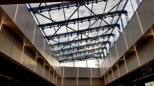 istock Structural glazing of the facade. Abstract background with glass ceiling elements in a modern building. view of the blue sky through a glass window, separated by lattice elements 1176785990