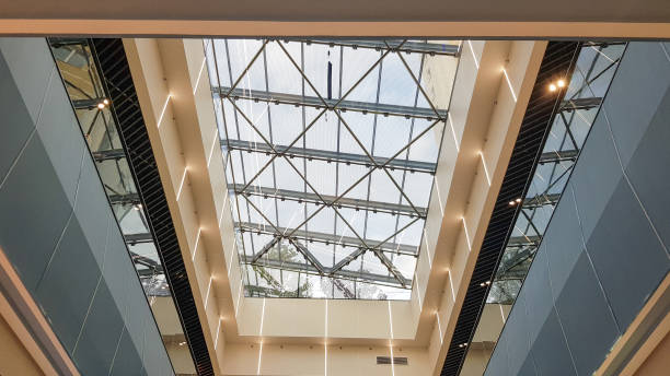 istock Structural glazing of the facade. Abstract background with glass ceiling elements in a modern building. view of the blue sky through a glass window, separated by lattice elements 1176786046