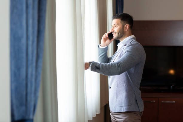 istock Sharp dressed businessman talking on the phone 1176786803