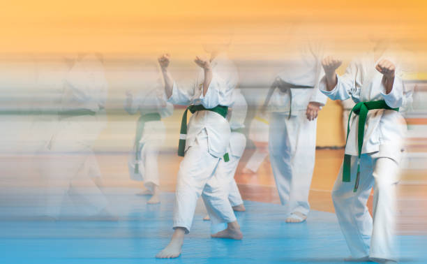 istock Kids training on karate-do. Banner with space for text. Retro style. For web pages or advertising printing. Photo without faces. 1176787460