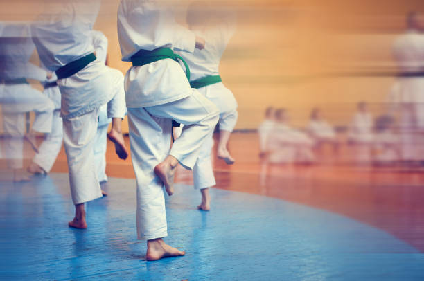 istock Kids training on karate-do. Banner with space for text. Retro style. For web pages or advertising printing. Photo without faces. 1176787462