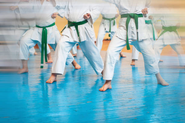 istock Kids training on karate-do. Banner with space for text. Retro style. For web pages or advertising printing. Photo without faces. 1176787469
