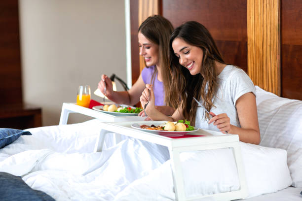 istock Beautiful young women eating in bed 1176788170