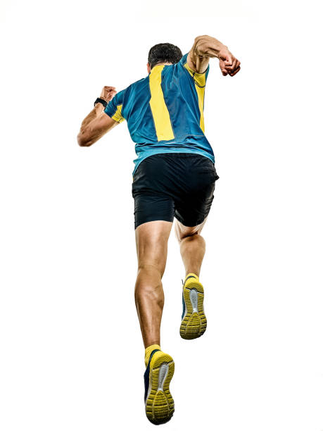 young male runner running on asphalt road against sky.