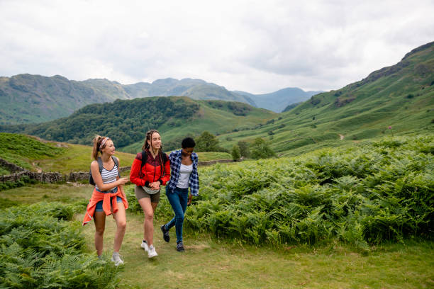 istock Three Young Girls Walking in the Lake District 1176791920