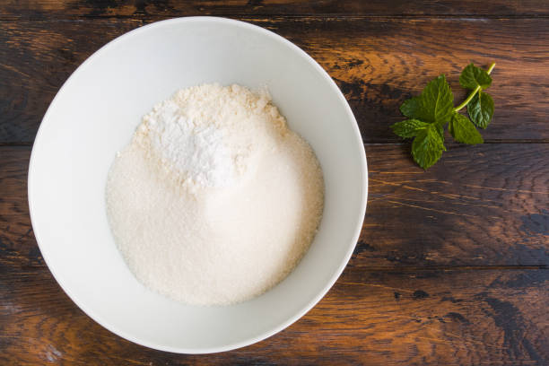 istock Dough making, flour, sugar and baking powder in white bowl. Wooden rustic table, top view 1176791950