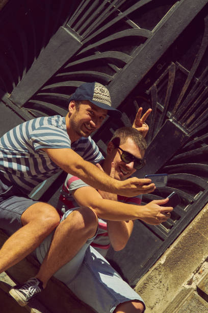 istock Male friends using cellphone outdoors. 1176792739