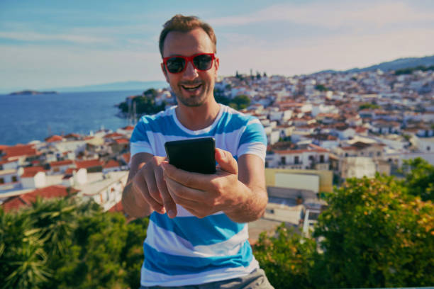 istock Attractive man using cellphone outdoors. 1176793924
