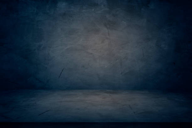 istock dark blue cement wall studio background, empty showroom to present product 1176794025
