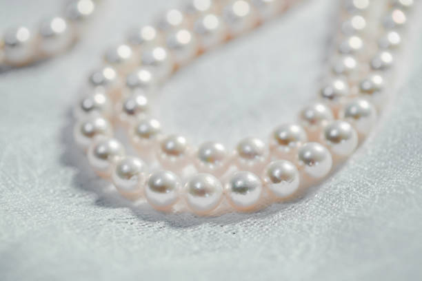 istock Pure white pearl necklace on cloth 1176794115