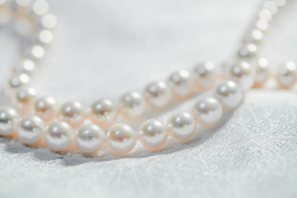 istock Pure white pearl necklace on cloth 1176794210