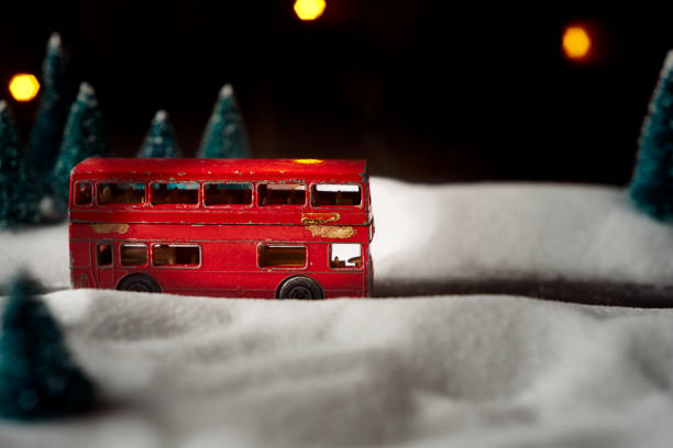 istock Selective focus on red toy bus in blurred imitation winter background 1176794297