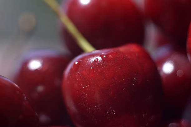 istock Background from sweet fresh red cherry, macro image. Cherry macro background with water drops. 1176794301