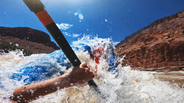 istock POV capsizing while rafting with kayak in Colorado river 1176795623
