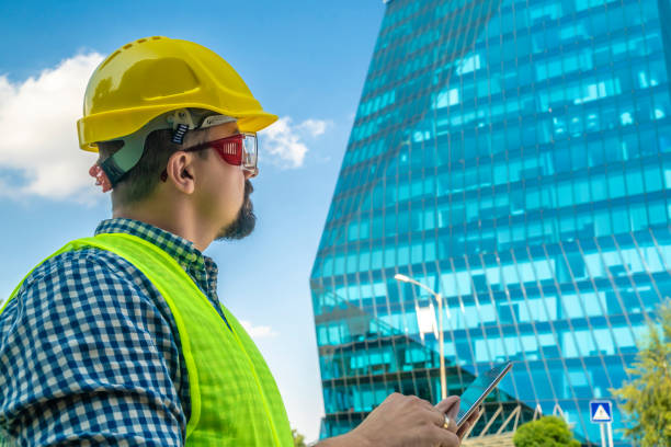 istock Construction engineer, architect or manual worker with digital tablet in front of modern building 1176795720