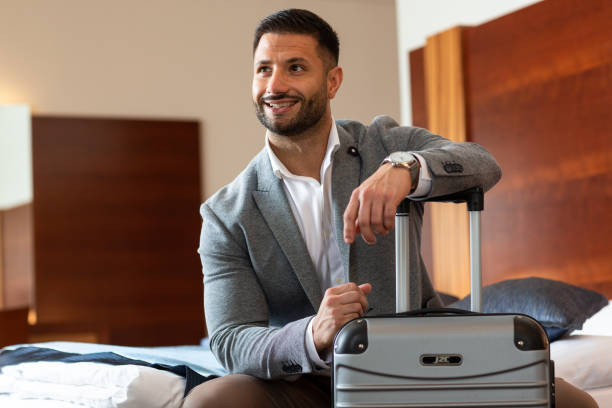 istock Businessman leaning on his luggage 1176795927