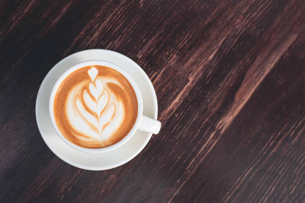 istock Cup of cappuccino on wooden table. 1176796820