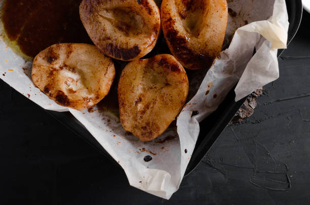 istock Caramelized Pears - Poached pears with spices in syrup on the white plate 1176797731