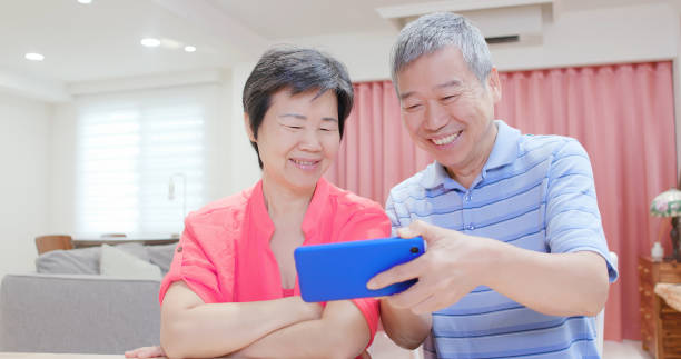 istock asian eldely couple watch video 1176797952