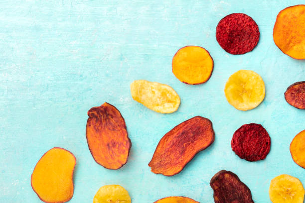 istock Dry fruit and vegetable chips, overhead shot on a vibrant blue background 1176798559