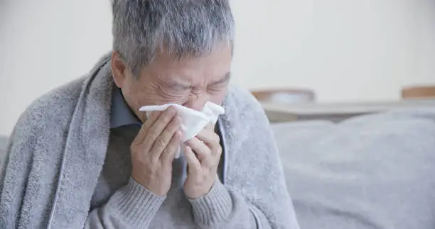 Photo of asian elderly sick man sneeze