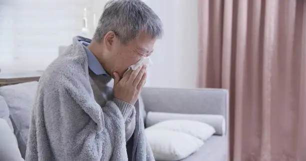 Photo of asian elderly sick man sneeze