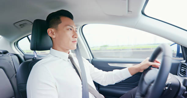 istock business asian man driving car 1176799631