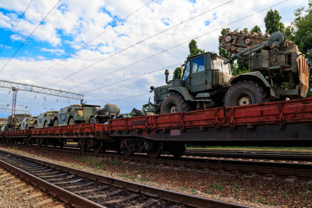 istock Cargo train carrying military vehicles on railway flat wagons 1176800979