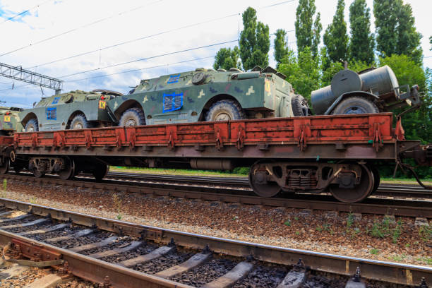 istock Cargo train carrying military vehicles on railway flat wagons 1176800989